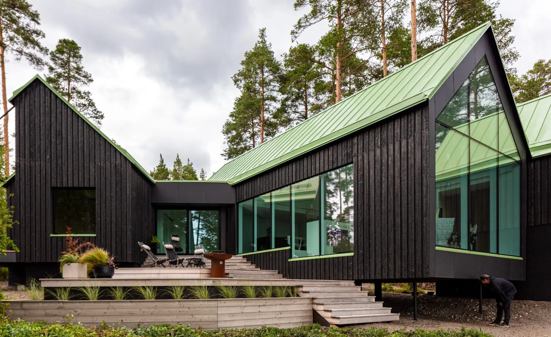 Charred timber clad house with a green roof